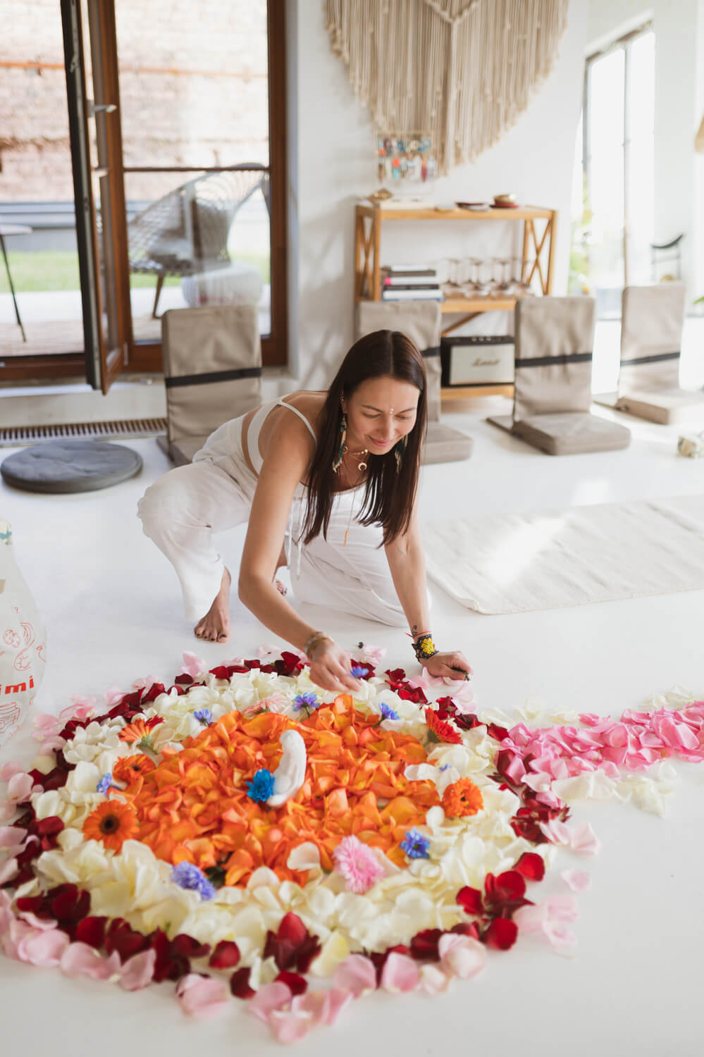 Woman arranging altar before a rapeh ceremony with flowers
