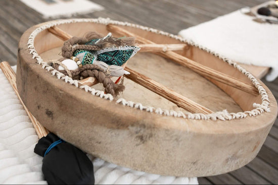 Real shaman drum with decorative elements on a textured surface