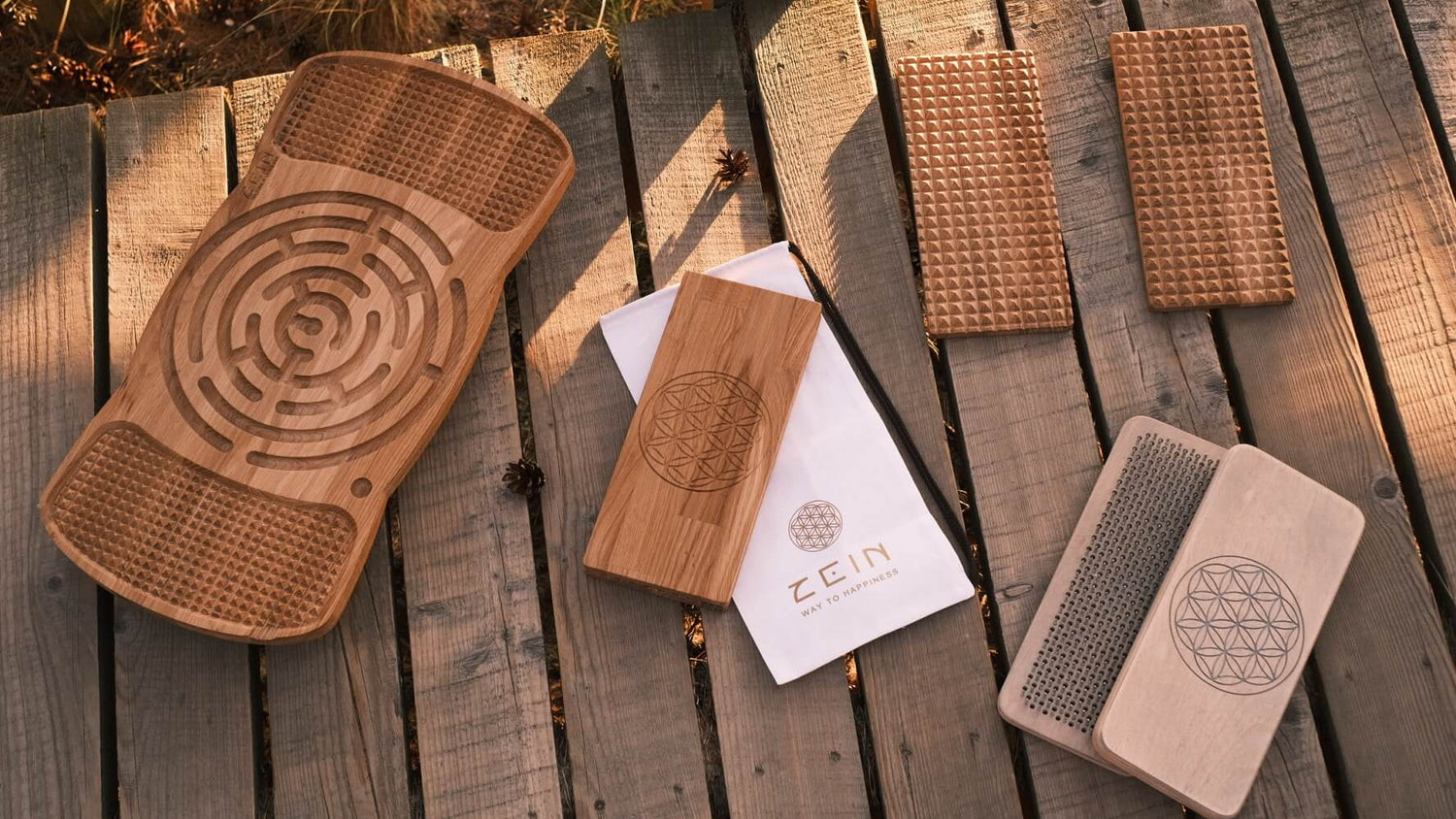 Wooden massage boards with geometric patterns on a wooden surface